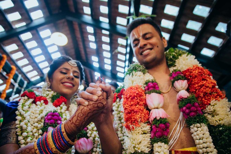 Groom holding bride’s hand for Paanigraham ritual