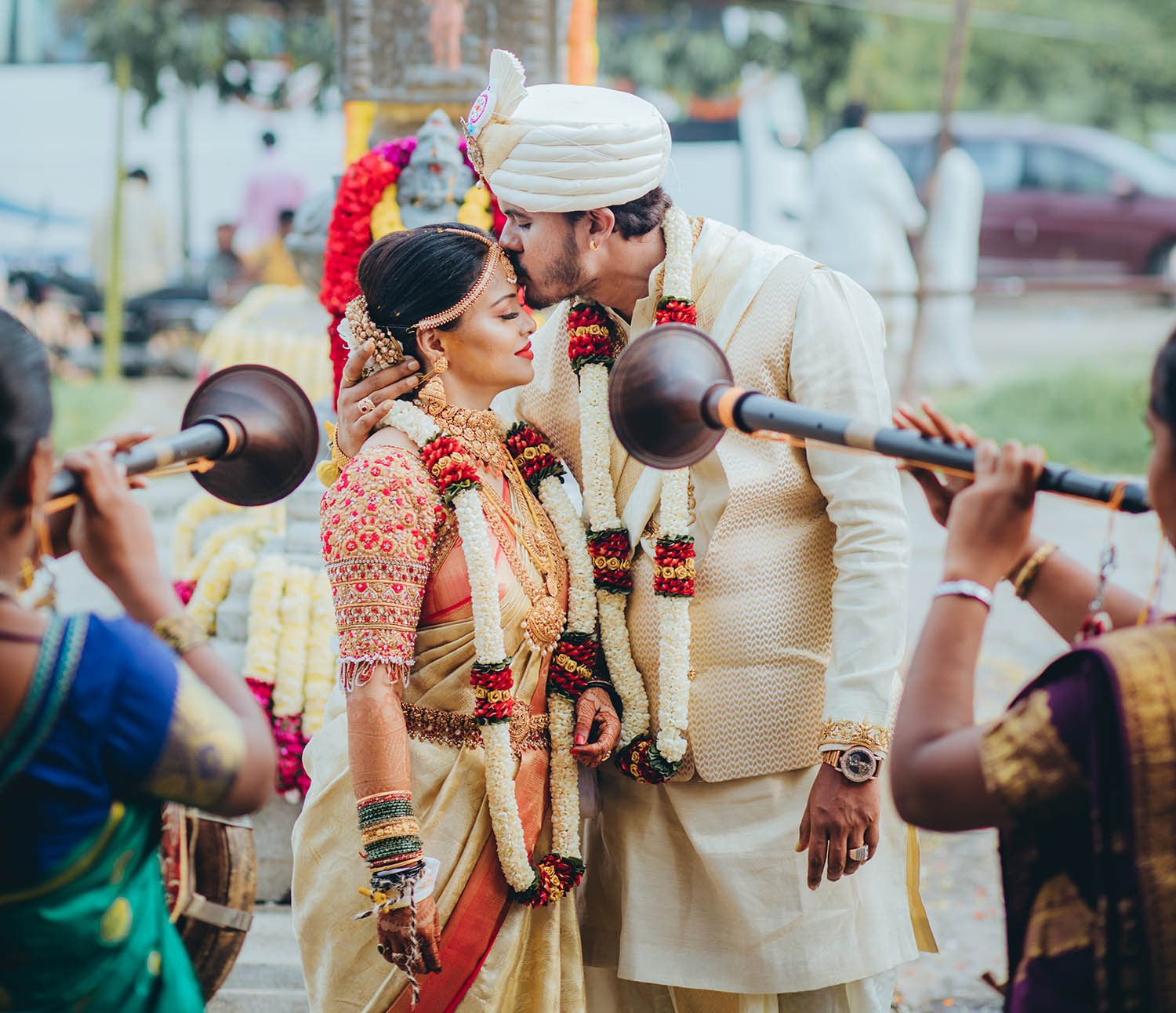 A Gowda wedding groom is loving kissing the bride’s forehead