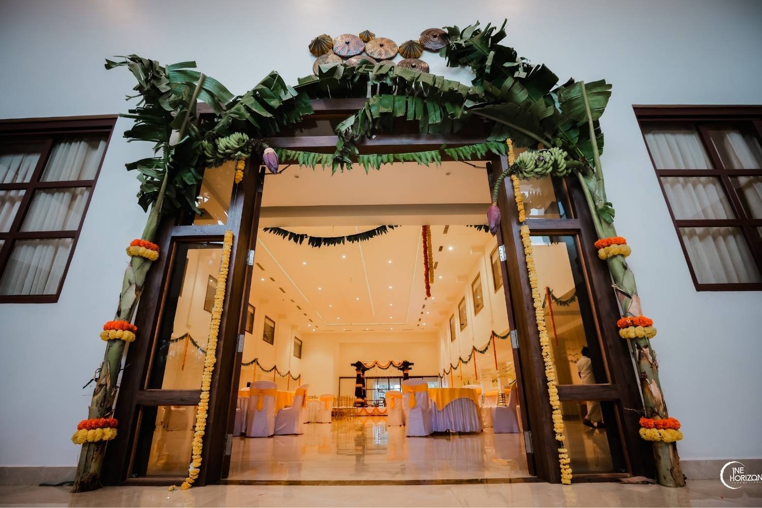 Banquet hall entrance at The Beginning is decorated with mango and banana leaves