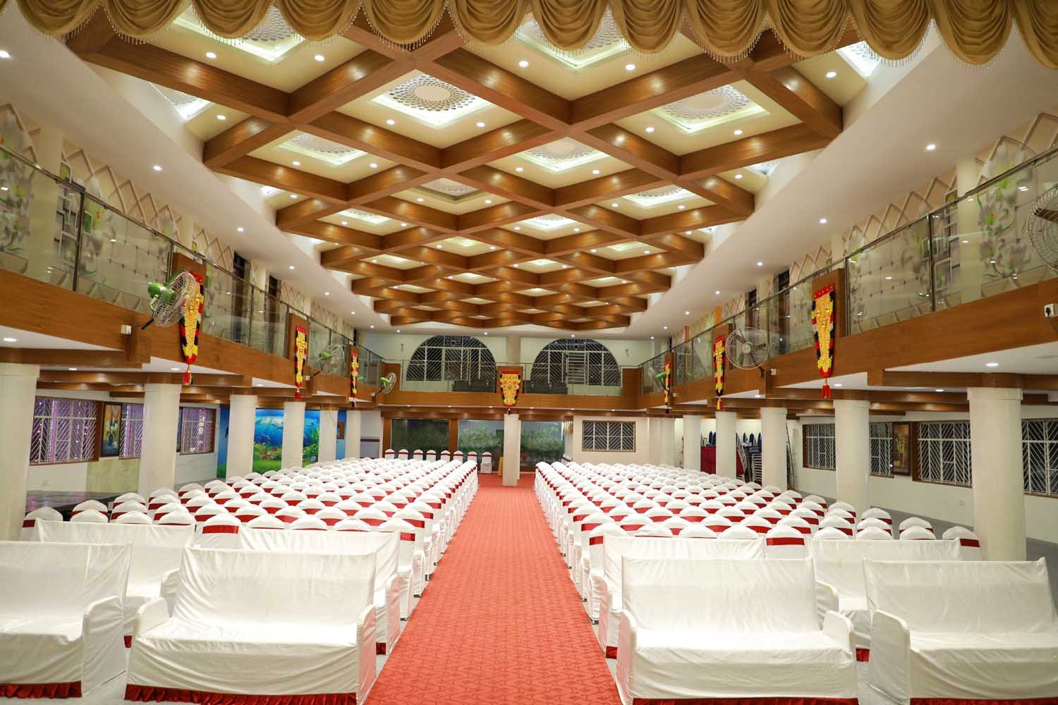 Majestic banquet hall with seating arrangements at PM Kalyana Mantapa