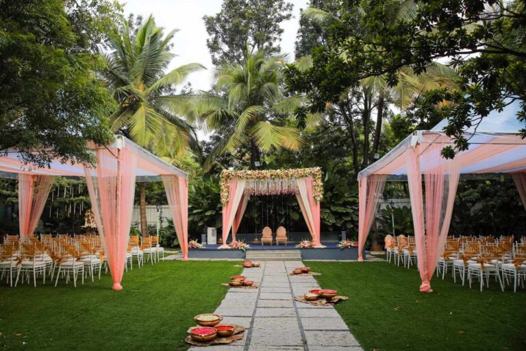 Destination wedding cost setup with outdoor mandap decor and seating arrangement at a garden venue